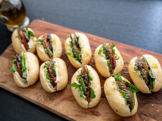 mini labneh rolls served on a wooden board