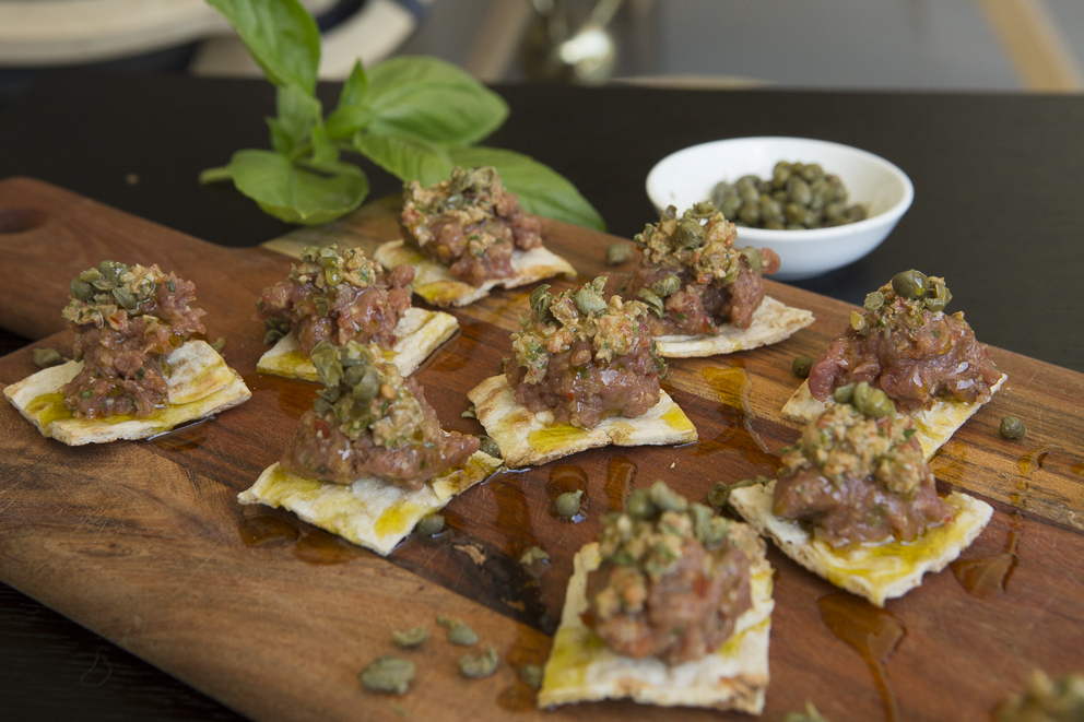 kibbeh nayeh hors d'oeuvre served on a wooden board
