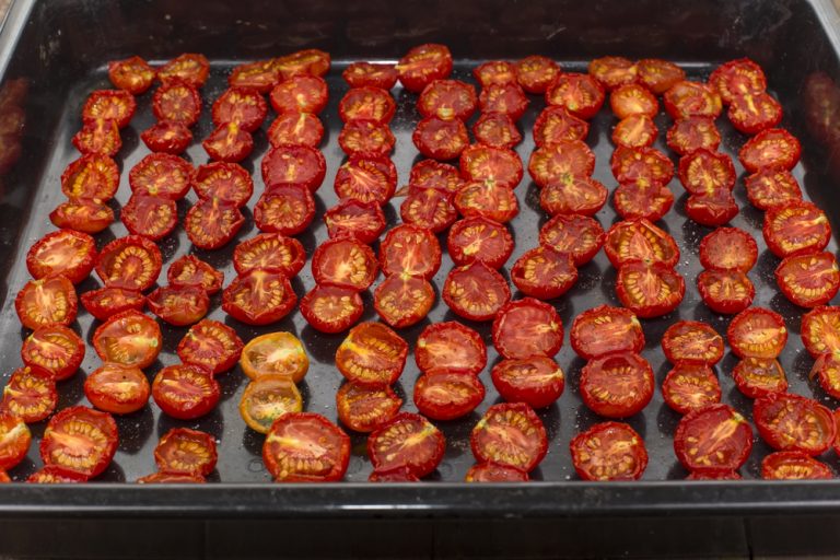 sun-dried tomato halves spread out on the baking