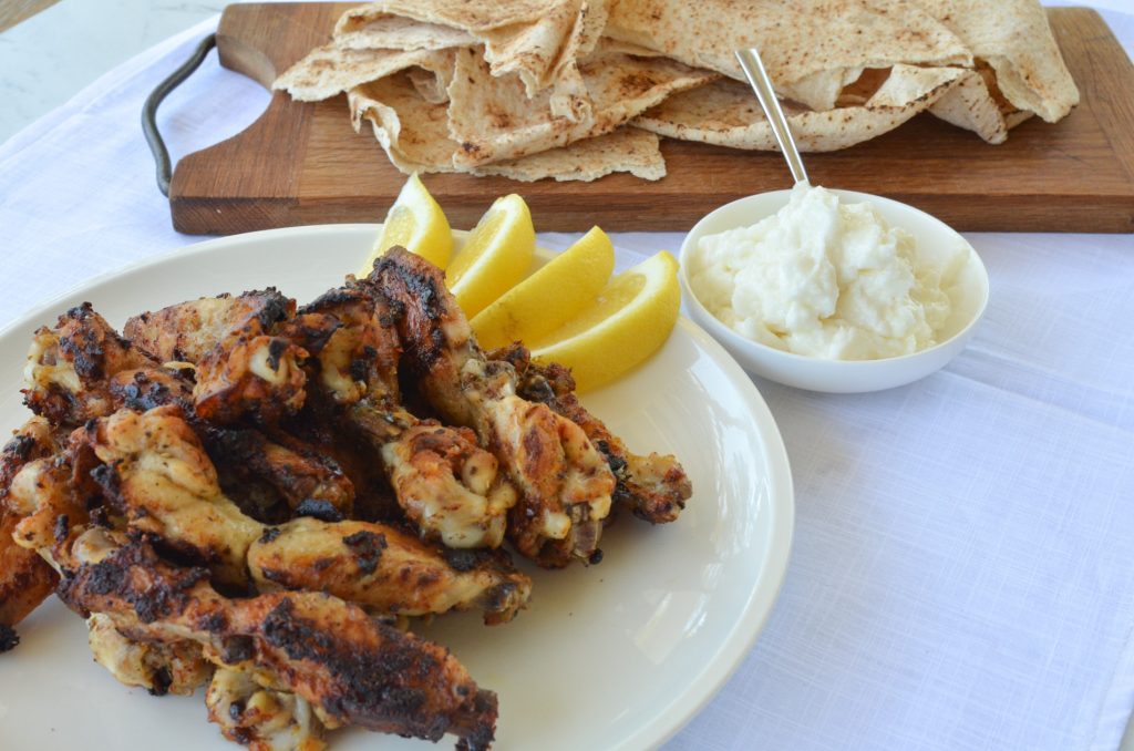 barbecued chicken wings served with garlic paste