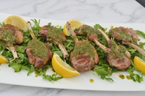 lamb cutlets and herb salsa served on a platter