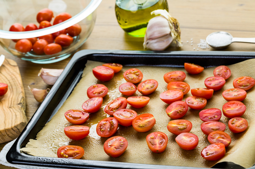 Preparing fresh roasted cherry tomatoes.
