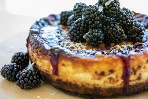 blackberry and white choc cheesecake served on a round board