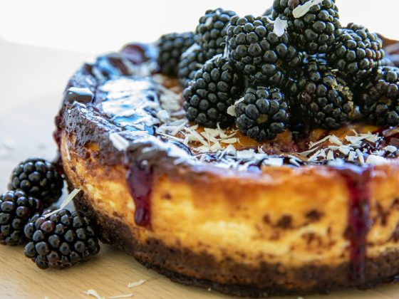 blackberry and white choc cheesecake served on a round board