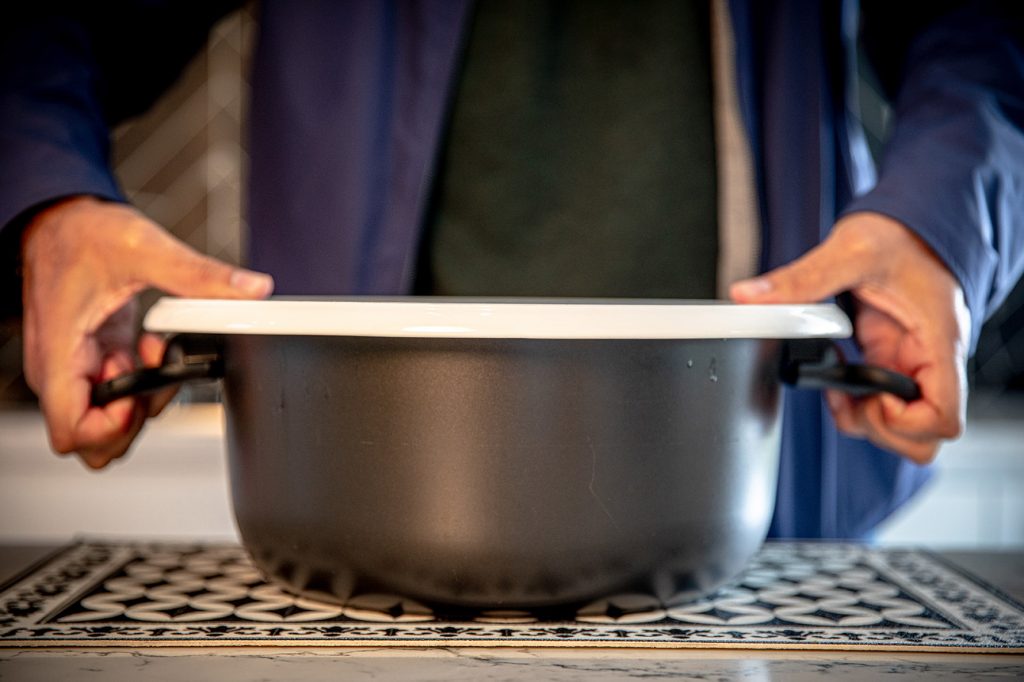 placing a flat plate over the pot