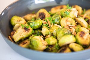 brussel sprouts garnished with parsley and slivered almonds