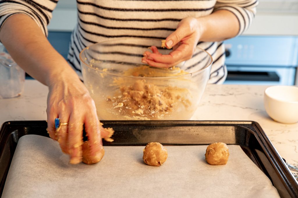 Dividing cookie mixture on tray