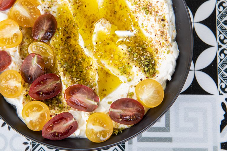 labneh garnished with pistachio and cherry tomatoes