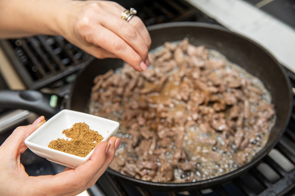 adding arabian spice to the cooked lamb